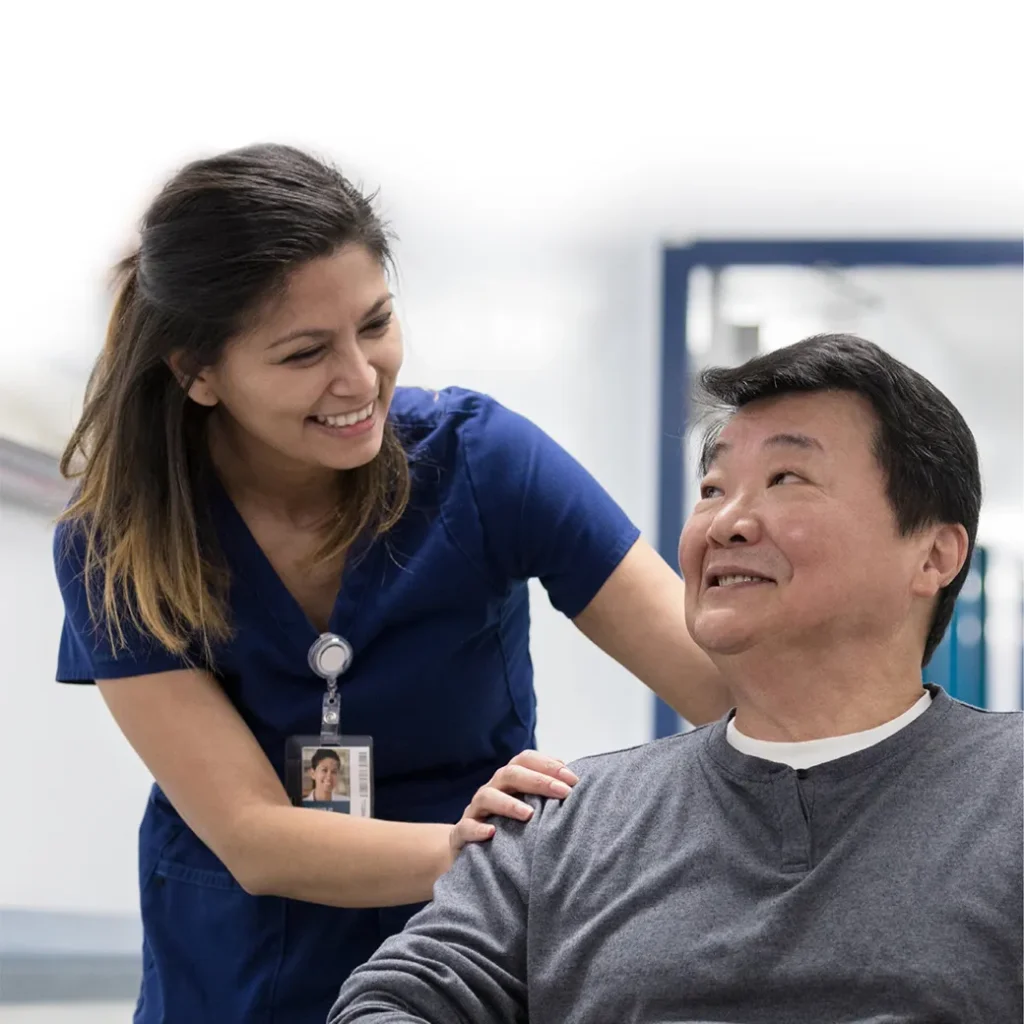 Smiling nurse assisting a patient in a medical setting.